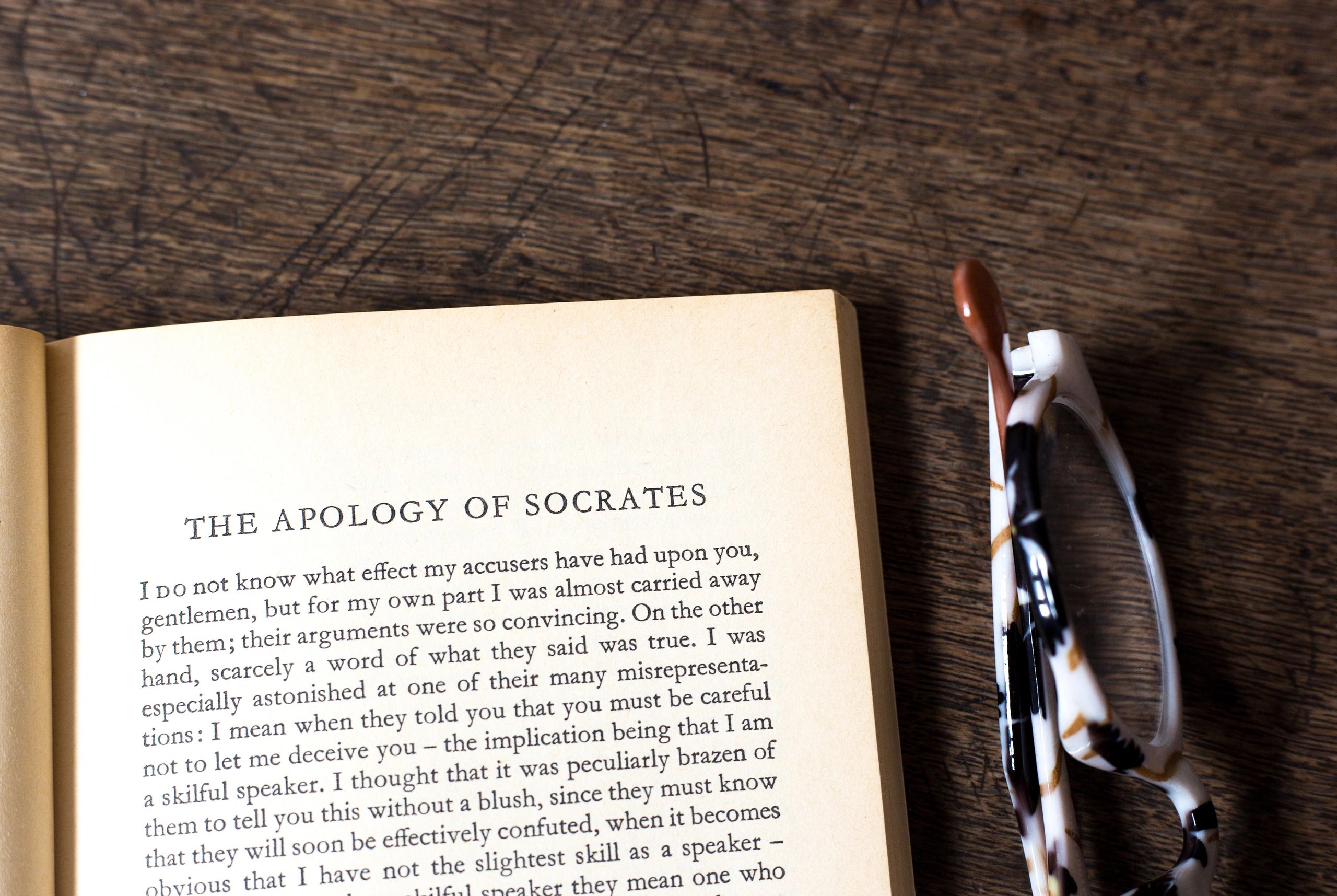 Open antique book with symbolic and philosophical atmosphere
