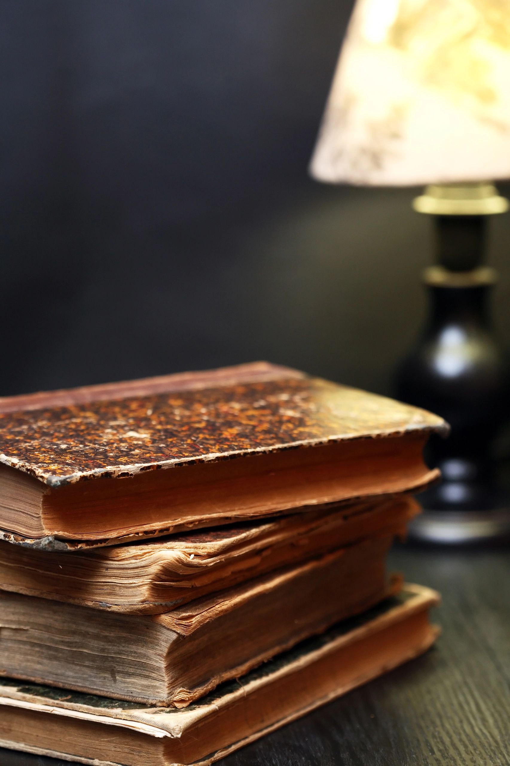 Old books beside a lamp suggesting study and reflection
